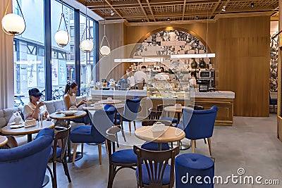 Modern european cozy cafe with upholstered blue furniture in Riga Old Town Editorial Stock Photo