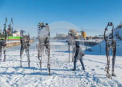Photographer taking photos of modern sculpture art in frost winter in February 2021 Editorial Stock Photo