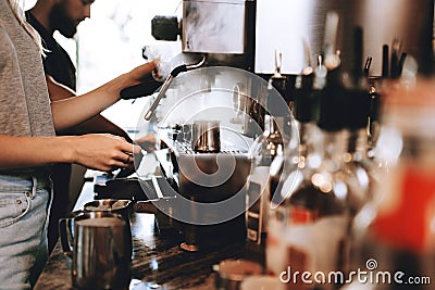 A modern expensive coffee machine is shown in work in modern cozy coffee shop. Stock Photo