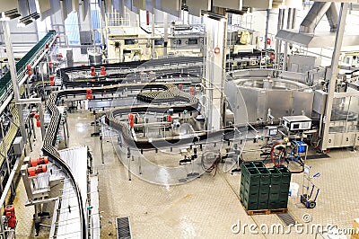Modern factory in the food industry - beer brewery - conveyor belt with beer bottles and machines for production Stock Photo
