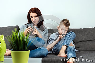 Modern family, everyone is sitting in smartphones than the passionate. The concept of harmfulness of modern gadgets, the Stock Photo