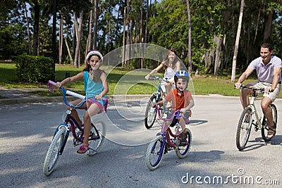 Modern Family Parents and Children Cycling Stock Photo