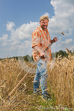 Modern farmer with scythe Stock Photo