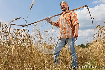 Modern farmer with scythe Stock Photo