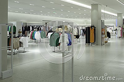 Modern fashionable brand interior of empty clothing store inside shopping center Stock Photo