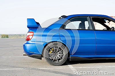 a modern fast race sport blue car on the track on summer practice day Stock Photo