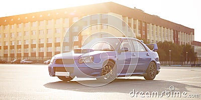 a modern fast race sport blue car on the track on summer practice day Stock Photo