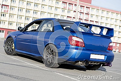 a modern fast race sport blue car on the track on summer practice day Stock Photo