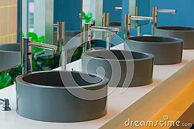 Modern faucet with black ceramic washbasin sink interior Stock Photo