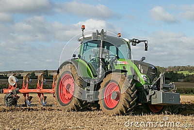 Modern fendt tractor pulling a plough Editorial Stock Photo