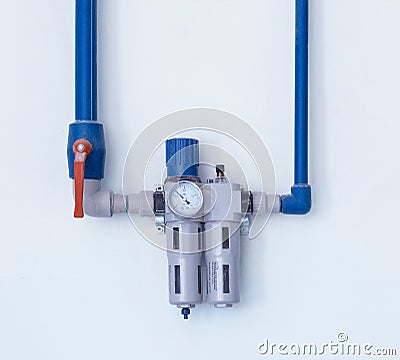 A modern filter with a water gauge for cleaning from debris and heavy metals, located on the wall, a water pipe water purification Stock Photo
