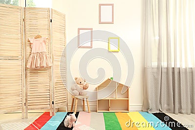 Modern folding screen in stylish baby room Stock Photo