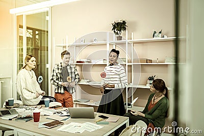 Modern freelancers gathering in coworking with thinking hats Stock Photo