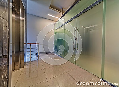 Modern frosted glass doors entrance near elevator Stock Photo