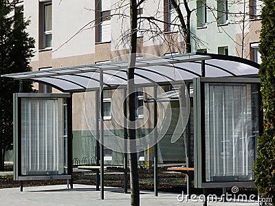 Modern glass bus shelter with polka dots on aluminum frame Stock Photo