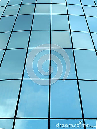 modern glass facade of a skyscraper in perspective with reflected clouds Stock Photo