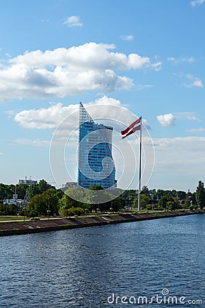 Modern glass skyscraper of Swedbank office and Latvian flag against blue sky in Riga city, Latvia, July 25, 2018 Editorial Stock Photo