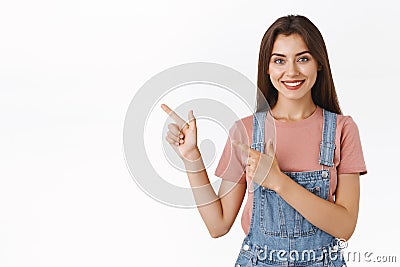 Modern good-lookin confident, assertive woman pointing upper left corner and smiling camera, recommend use promo coupon Stock Photo