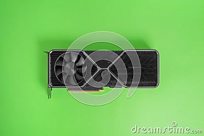Modern graphic card on green surface. Massive radiator with two coolers Stock Photo