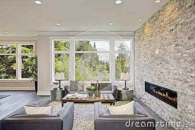Modern great room with a floor to ceiling stone fireplace Stock Photo