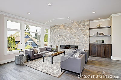 Modern great room with a floor to ceiling stone fireplace Stock Photo