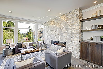 Modern great room with a floor to ceiling stone fireplace Stock Photo