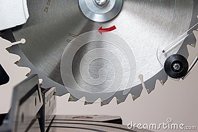 Modern green circular saw lies on a wooden table. Circular saw blade for wood with hard alloy insertions Stock Photo