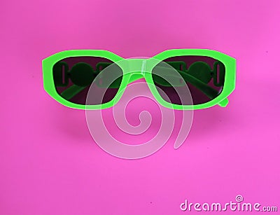 Modern green sunglasses isolate on a pink background.Traveler and summer accessories Stock Photo