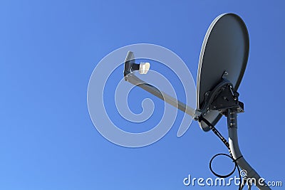 Modern HD Satellite Dish On A Clear Blue Sky Day Stock Photo