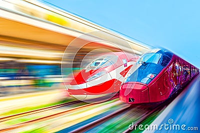 Modern hi-speed passenger train, in movement (motion) on railways station Stock Photo