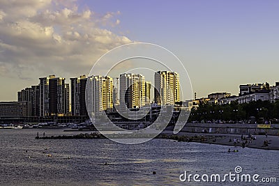 Modern high-rise buildings on the coast embankment of a seaside town at sunset Editorial Stock Photo