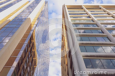 Modern high rise buildings with golden shine and blue sky reflection Stock Photo