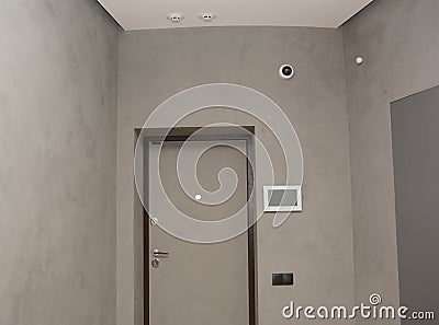 Modern house entrance metal door interior with smart house system, security camera, smoke alarms and fire detection Stock Photo