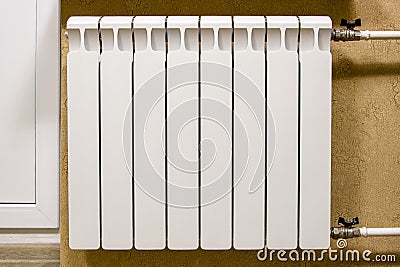 Modern home white radiator heating. Replacement, repair, installation of radiators, close-up photo. Stock Photo