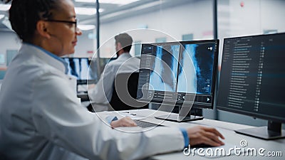 Modern Hospital Laboratory: Black Female Medical Doctor is Working on Computer Analysing Chest Stock Photo