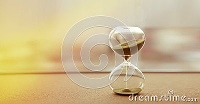 Modern hourglass with sand color background, as time passing concept for business deadline, urgency and running out of time Stock Photo