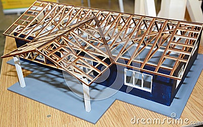 A modern house construction scale model, miniature architecture project with a detailed wooden roofing construction, wooden Stock Photo