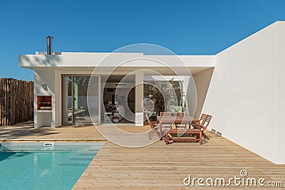 Modern house garden swimming pool and wooden deck Stock Photo