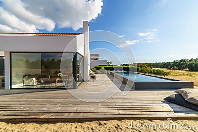 Modern house with garden swimming pool and wooden deck Stock Photo