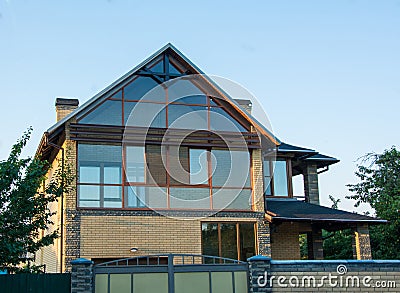 Modern house with glazed facade. Brick house with panoramic windows Stock Photo