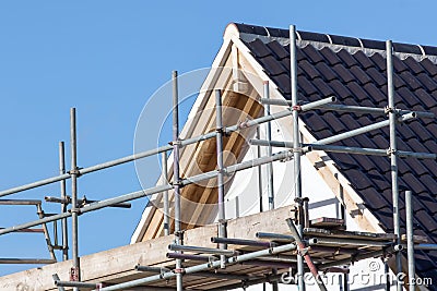 Modern house roof construction with scaffold pole platform Stock Photo