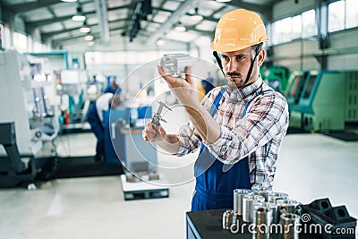 Modern industrial machine operator working in factory Stock Photo