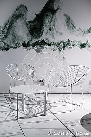 Modern interior in the Art Nouveau style. light colors in the interior of the cafe. elegant metal chairs in white with a coffee ta Editorial Stock Photo
