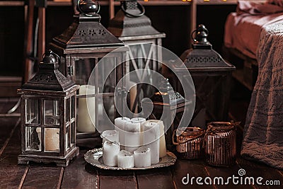 Modern interior and home decor concept. With candles, lanterns and candlesticks. Wooden parts Stock Photo