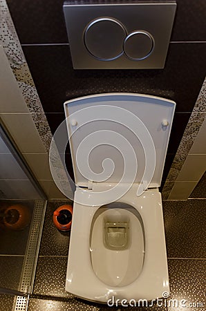 Modern interior toilet with white ceramic toilet bowl in a renovated home Stock Photo