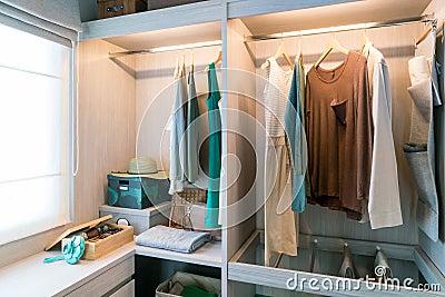 Modern interior wardrobe with shirt and dress in shelf. Stock Photo