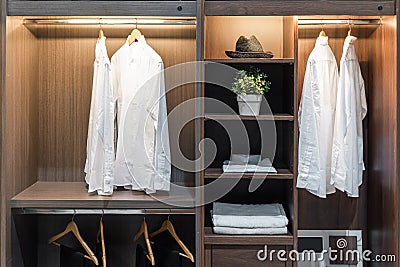 Modern interior wardrobe with shirt, pants, hat and towel Stock Photo