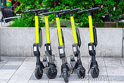 Modern Ñity transport - Five electric scooters are parked on the street of the city Stock Photo
