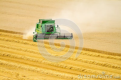 Modern John Deere combine harvester cutting crops Editorial Stock Photo