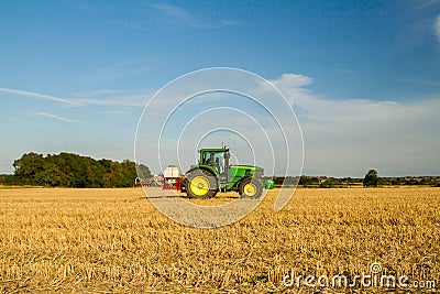 Modern john deere tractor Tractor spraying field stubble crops Editorial Stock Photo